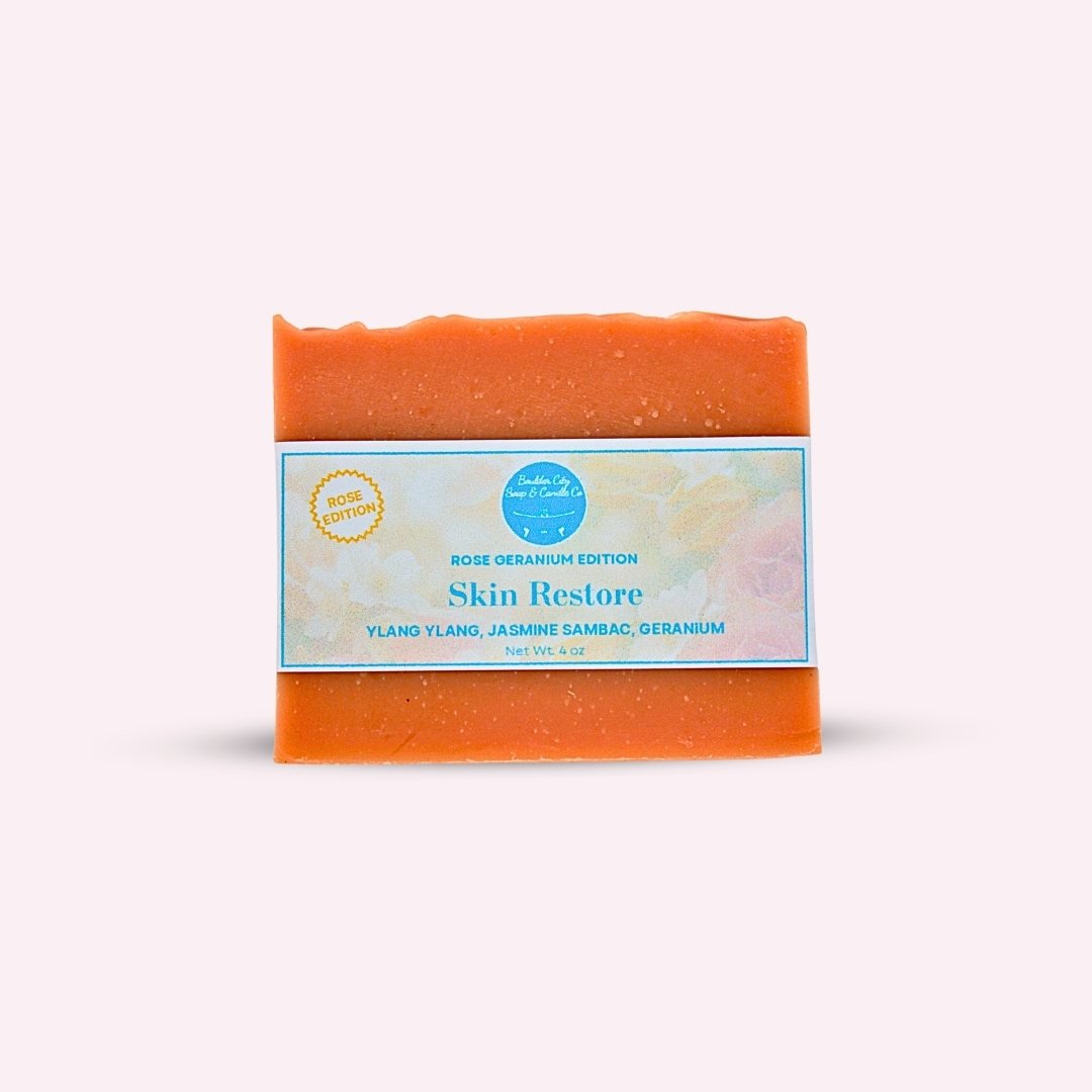Peachy rose Skin Restore Rose Geranium handmade 4 oz bar soap with a floral label on a pale pink background.